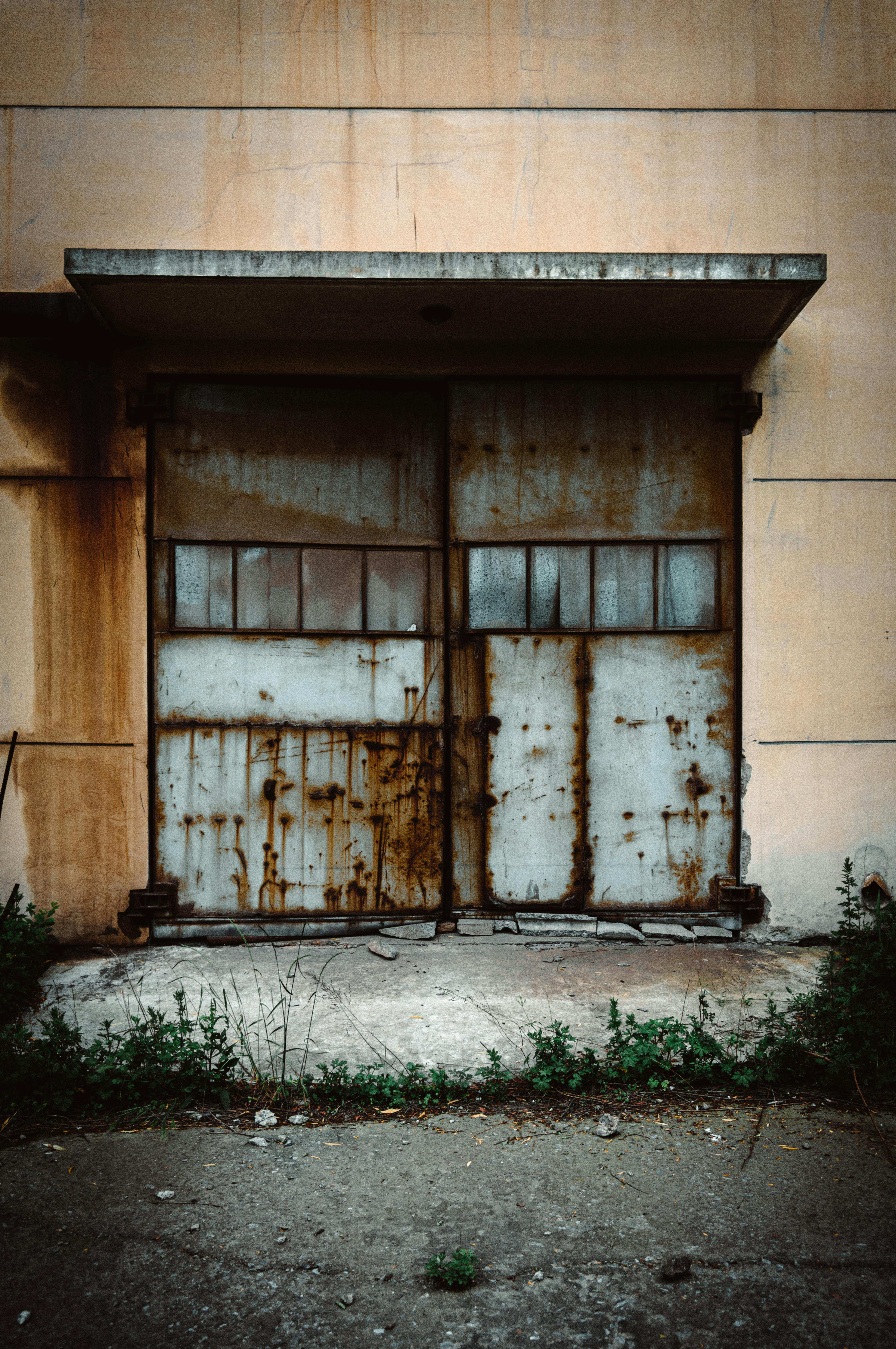 Before: Old weathered garage door with rust and damage