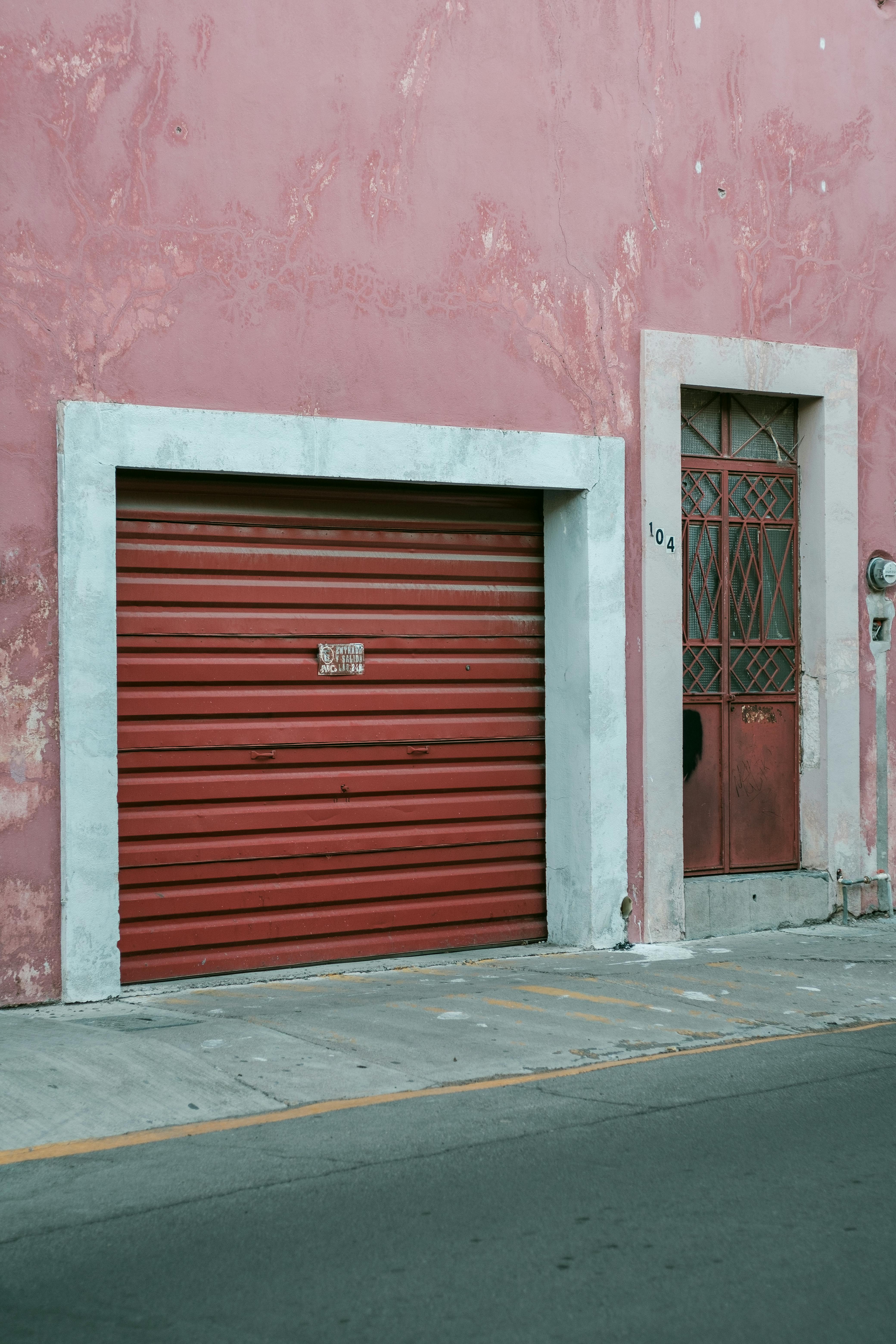 Before: Faded red roll-up garage door